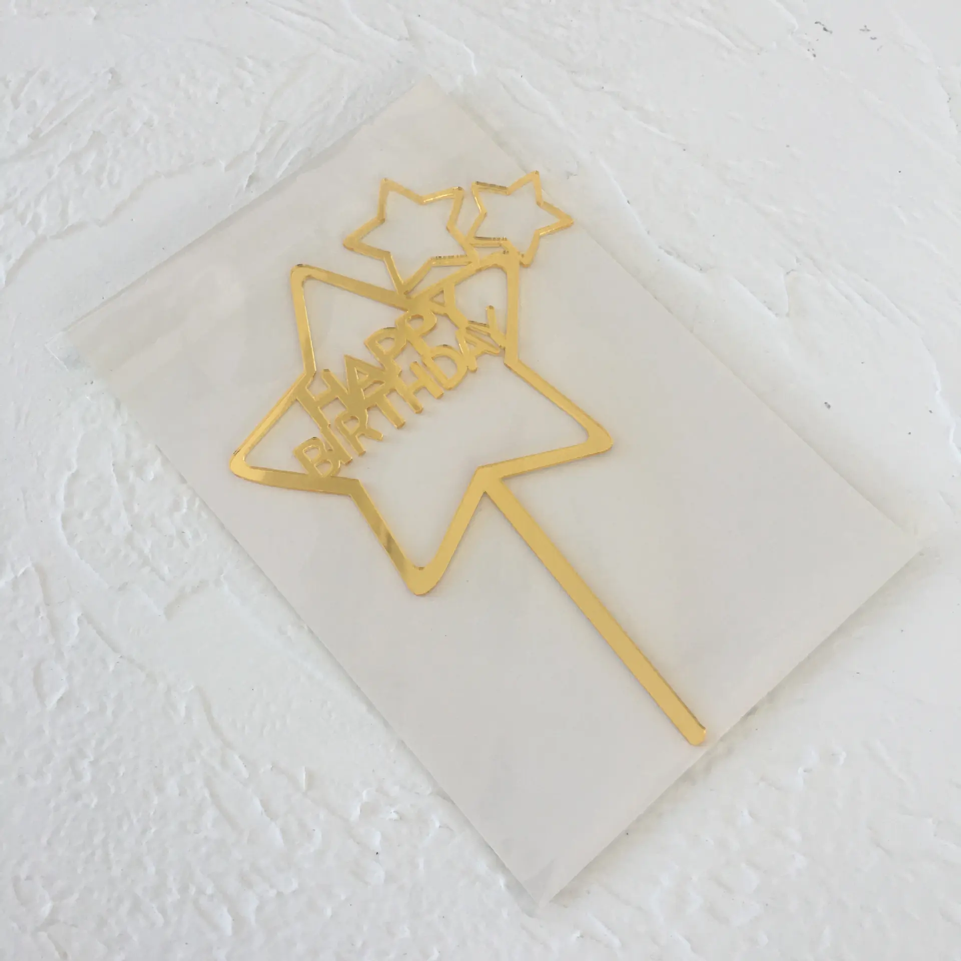 Golden star shaped happy birthday cake topper